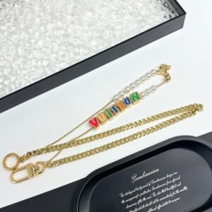 Golden Chain belt made of pearls, beads,metallic letters that spell out VU!TT0N.JW01
