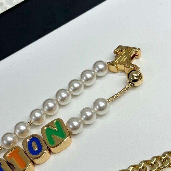 Golden Chain belt made of pearls, beads,metallic letters that spell out VU!TT0N.JW01 - Image 3