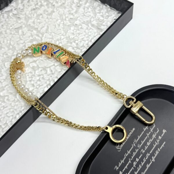 Golden Chain belt made of pearls, beads,metallic letters that spell out VU!TT0N.JW01 - Image 5