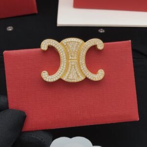 Brooch with logo Diamonds in golden and silver.JW01