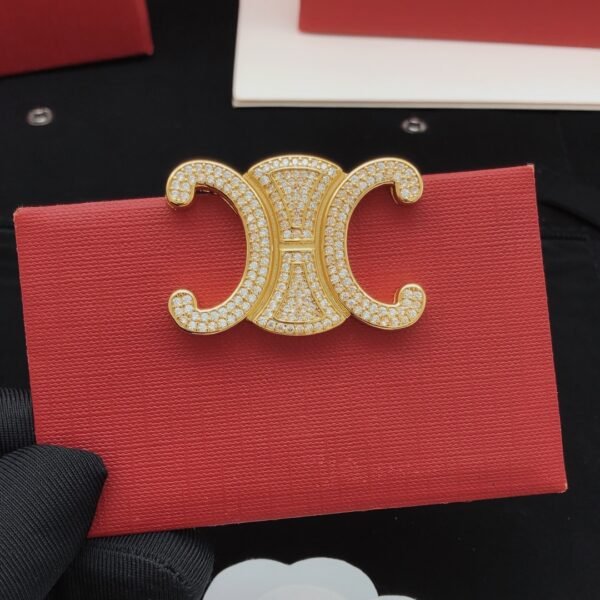 Brooch with logo Diamonds in golden and silver.JW01