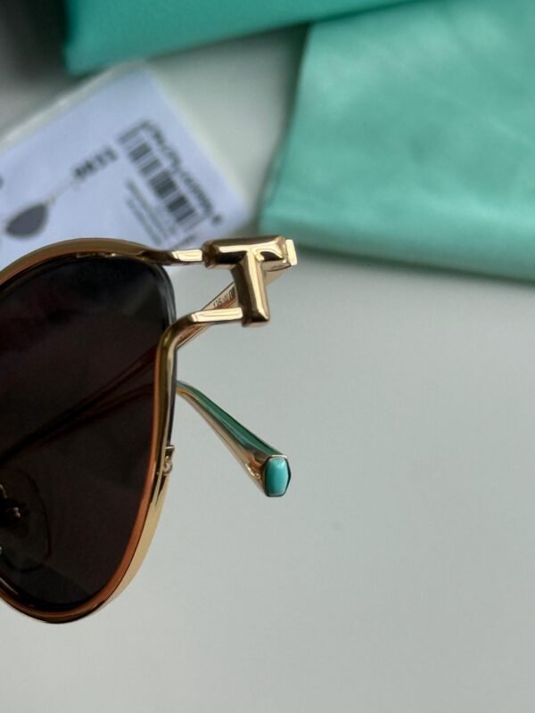 Sunglasses in Pale Gold-colored Metal with Black cat-eye shaped lenses. - Image 3