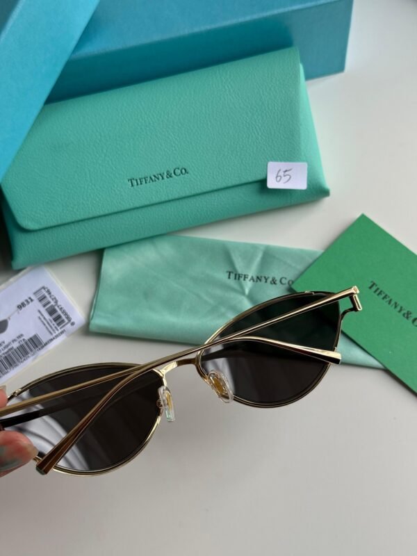 Sunglasses in Pale Gold-colored Metal with Black cat-eye shaped lenses. - Image 5