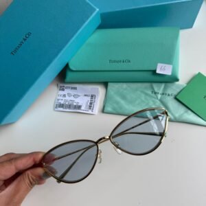 Sunglasses in Pale Gold-colored Metal with Blue cat-eye shaped lenses.