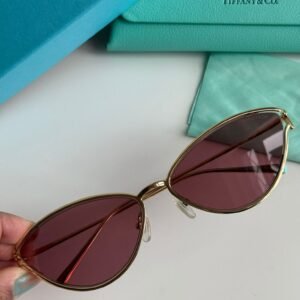 Sunglasses in Pale Gold-colored Metal with Pink cat-eye shaped lenses.
