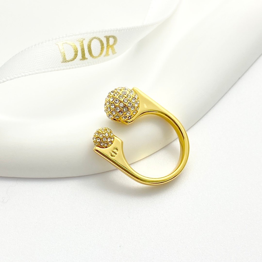 Gold-plated metal ring with unique Diamond covered balls design.