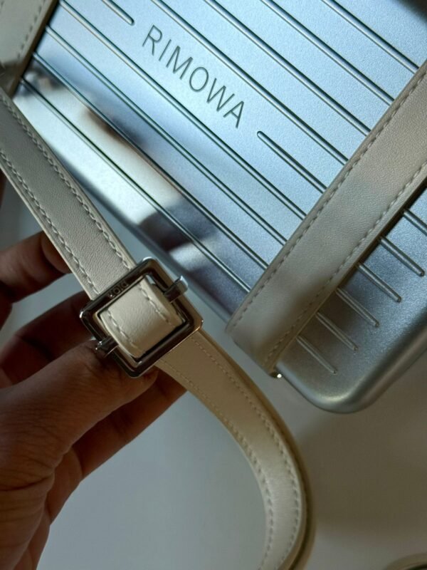Spring 2020 Personal Clutch On Strap lightweight aluminum with logo-embossed leather straps, refined interior layout with compartments, card slots, and a zippered pocket. - Image 13