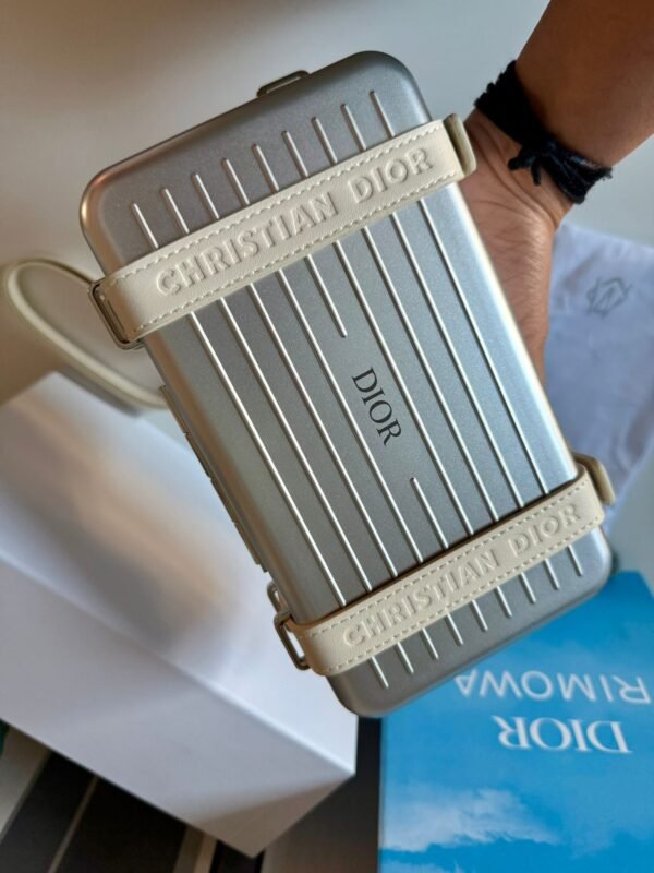 Spring 2020 Personal Clutch On Strap lightweight aluminum with logo-embossed leather straps, refined interior layout with compartments, card slots, and a zippered pocket. - Image 5