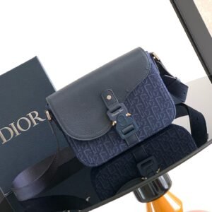 Saddle flap messenger bag made of navy blue printed fabrics with grained cowhide saddle flap.