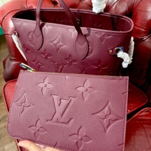 Alternative view of Genuine Leather Neverfull MM Burgundy tote bag with a matching pouch, both featuring embossed monogram pattern.