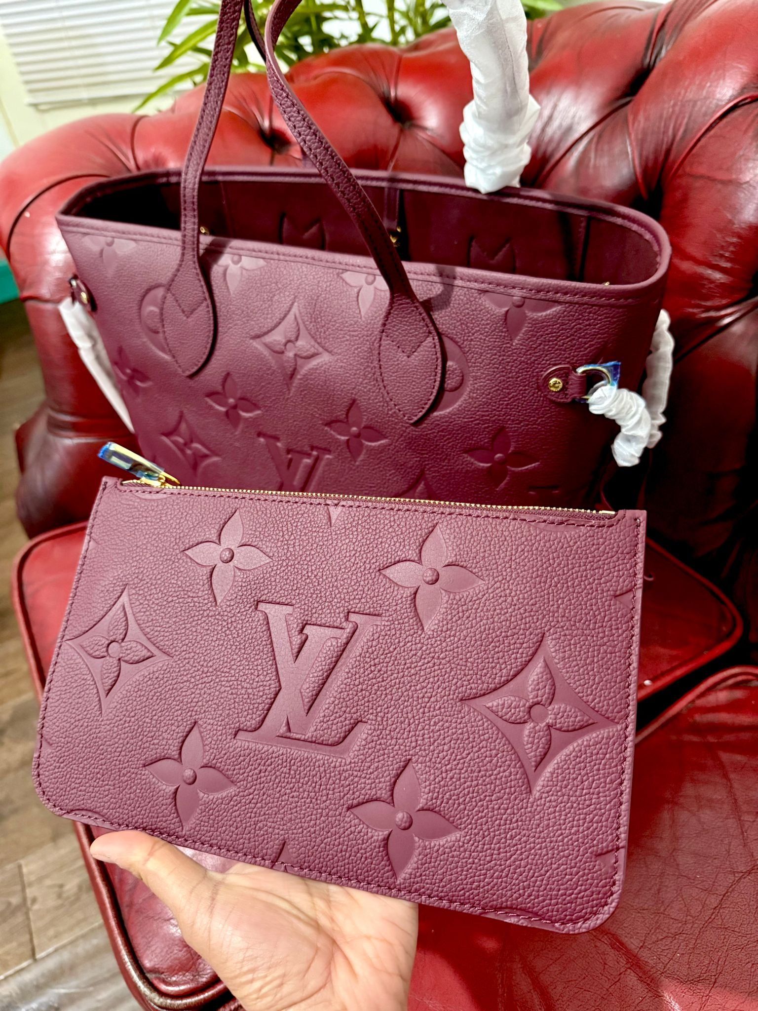 Genuine Leather Neverfull MM Burgundy tote bag with a matching pouch, both featuring embossed monogram pattern. - Image 2