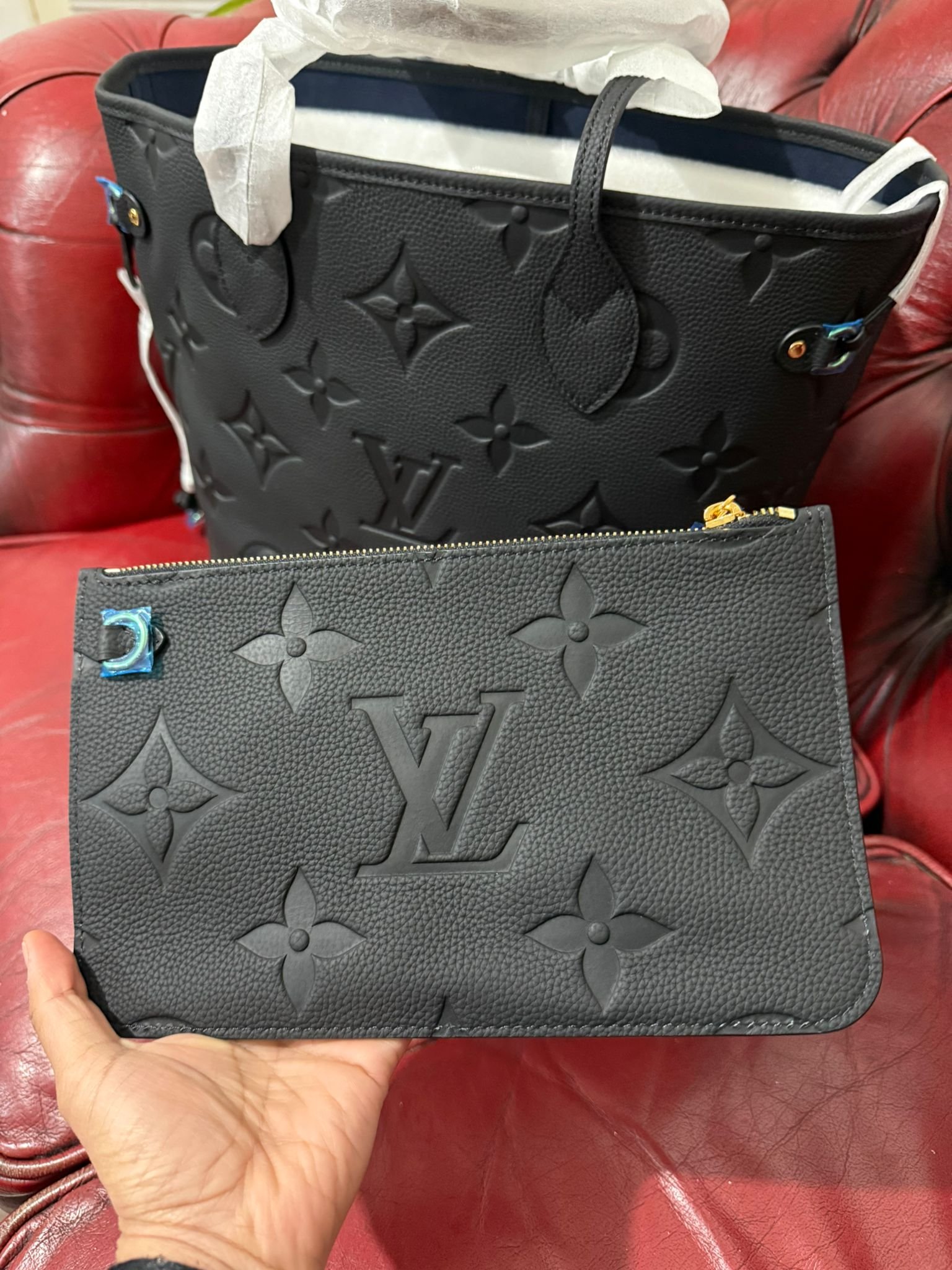 Genuine Leather Neverfull MM Black tote bag with a matching pouch, both featuring embossed monogram pattern. - Image 2