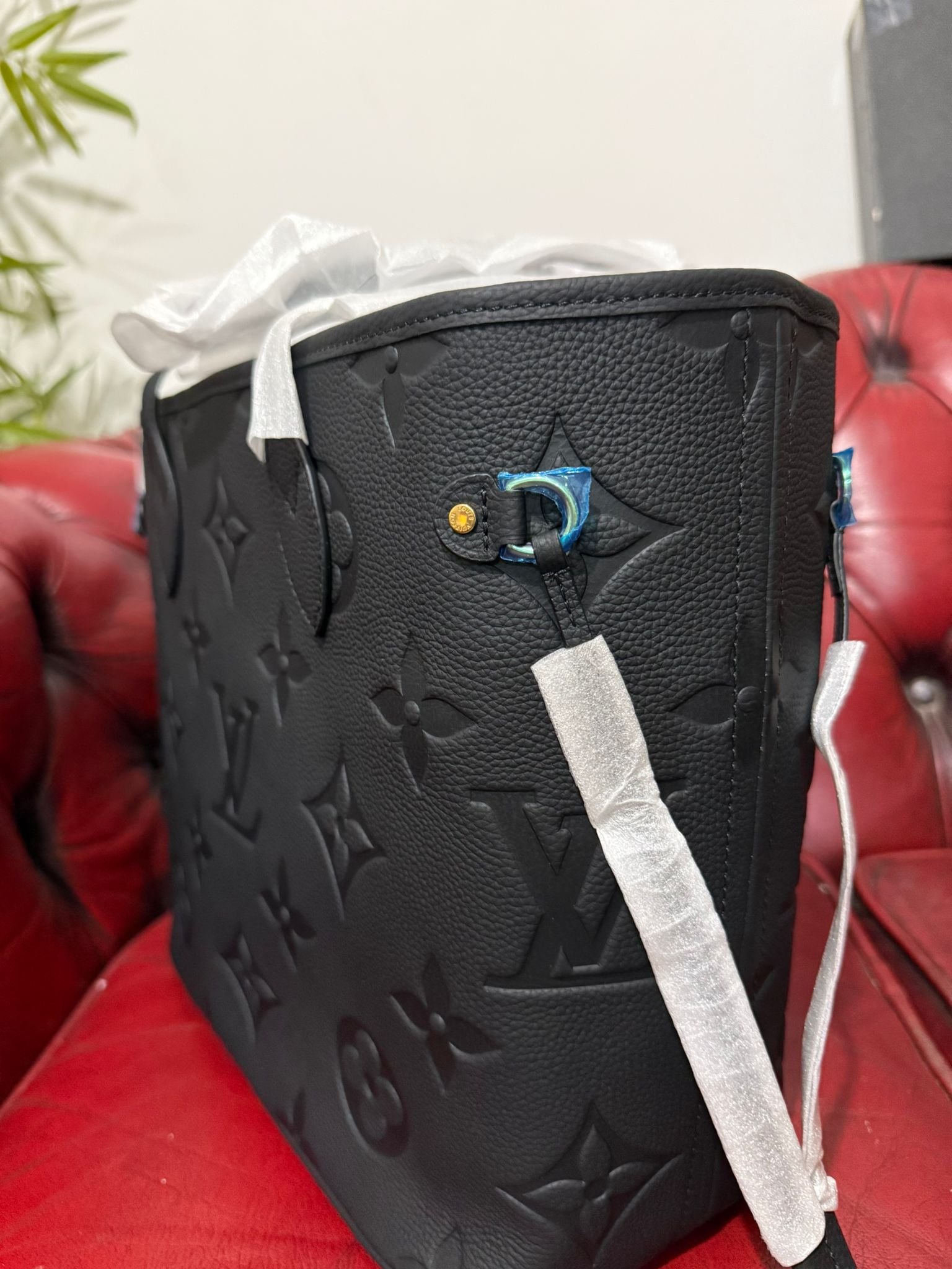 Genuine Leather Neverfull MM Black tote bag with a matching pouch, both featuring embossed monogram pattern. - Image 3