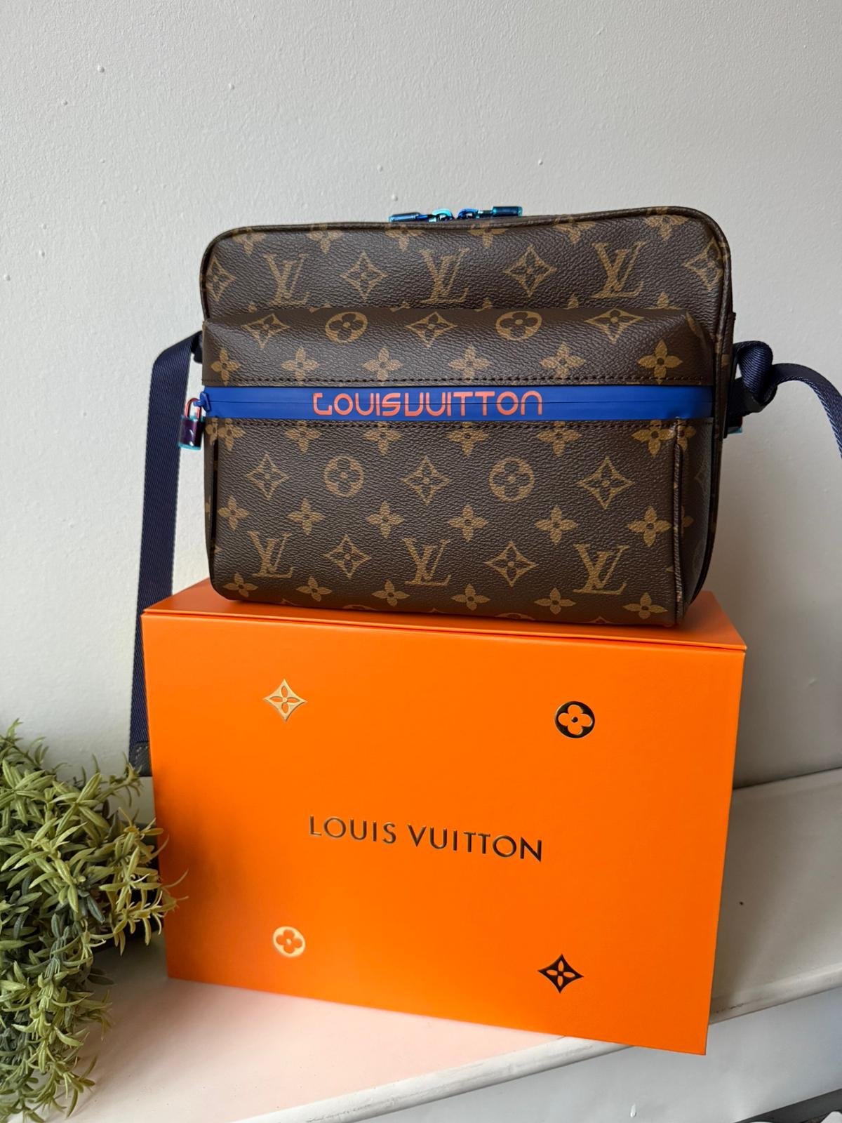 Limited edition Classic brown Monogram canvas compact cross-body bag with blue zip and blue hardware.