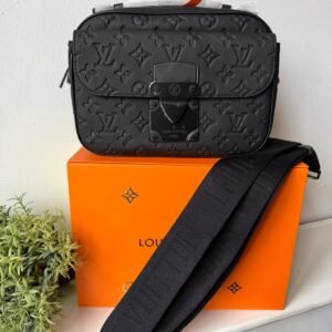 S Lock Messenger crafted in supple black Taurillon leather and embossed with Monogram pattern.
