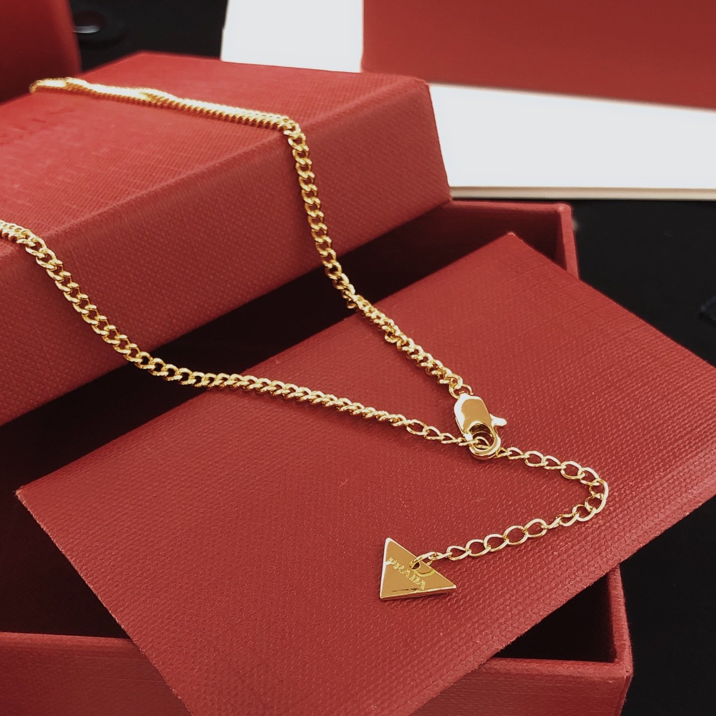 Gold-tone chain necklace featuring a black enamel triangle logo pendant consistent ZP brass.. - Image 6