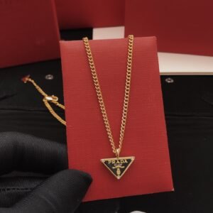 Gold-tone chain necklace featuring a black enamel triangle logo pendant consistent ZP brass..