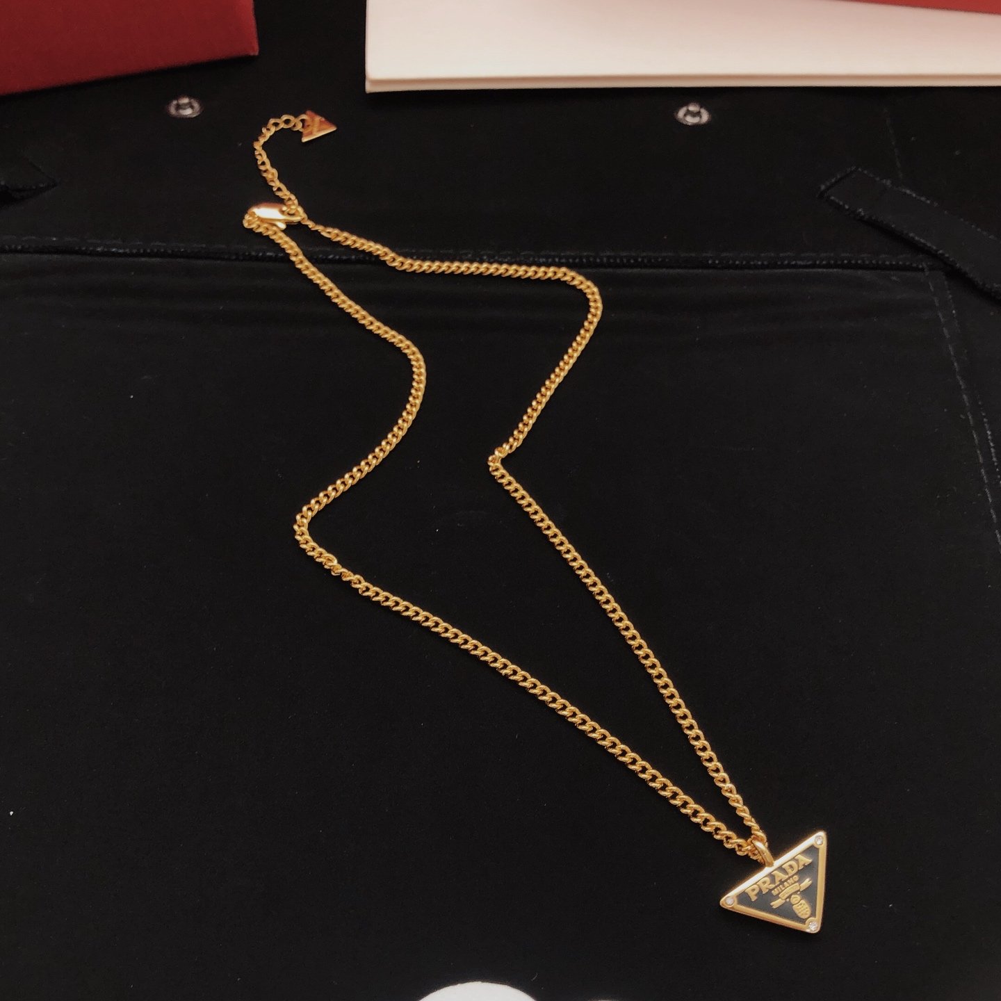 Gold-tone chain necklace featuring a black enamel triangle logo pendant consistent ZP brass.. - Image 5