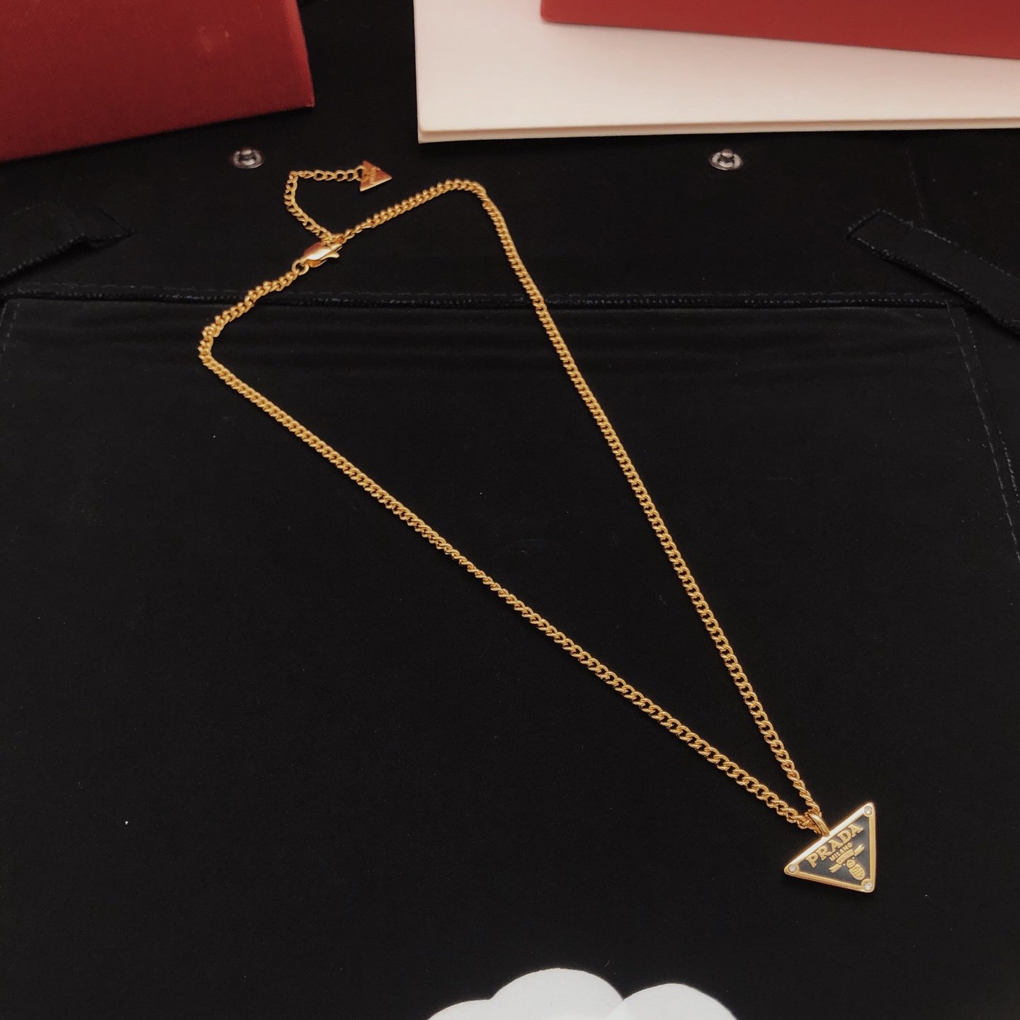 Gold-tone chain necklace featuring a black enamel triangle logo pendant consistent ZP brass.. - Image 7