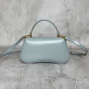 Alternative view of Mini baguette or Teen Triomphe bag in soft Sea Green shiny calfskin leather, featuring the brand's signature gold-finished metal clasp.