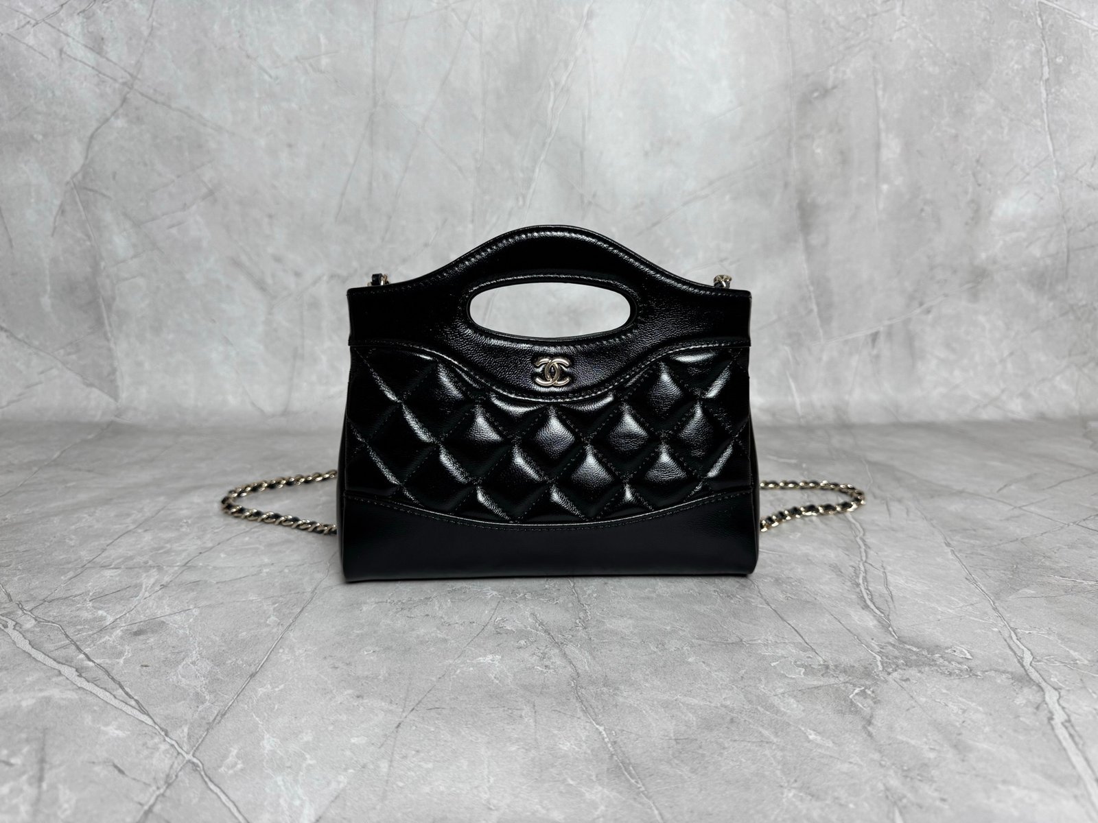 31 Nano Shopping Bag crafted from quilted shiny calfskin leather.