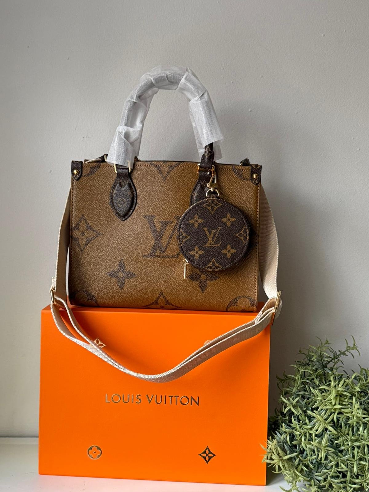 OnTheGo tote bag made from a mix of Monogram and Monogram Reverse canvas with detachable coin purse.