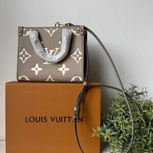 Dove Gray/Cream OnTheGo BB made from Monogram Empreinte leather, with Monogram embossing and a removable and adjustable shoulder strap.