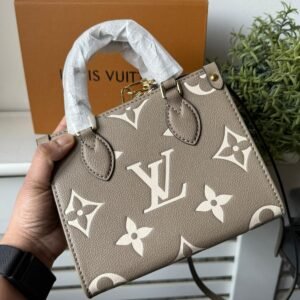 Alternative view of Dove Gray/Cream OnTheGo BB made from Monogram Empreinte leather, with Monogram embossing and a removable and adjustable shoulder strap.