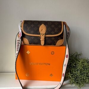 The Diane satchel in Monogram canvas and a well-organized interior. The exclusive wide jacquard strap reverses from a bold Louis Vuitton signature to a subtle Monogram Flower motif.