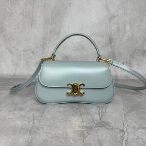 Mini baguette or Teen Triomphe bag in soft Sea Green shiny calfskin leather, featuring the brand's signature gold-finished metal clasp.