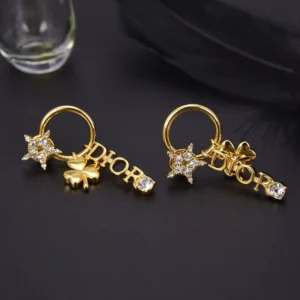 Drop earrings with D!0r letter and diamond inlaid charms.