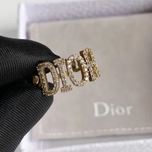 Alternative view of Gold ring with gems and brand name engraved on it.