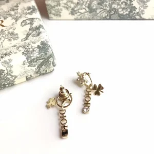 Golden drop earrings with D!Or cut out.