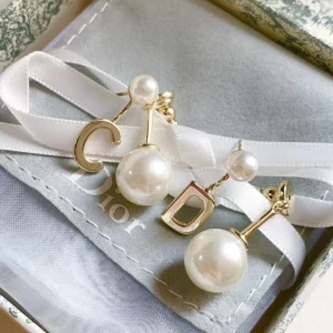 Alternative view of Golden drop earring with D cut out and white pearls.