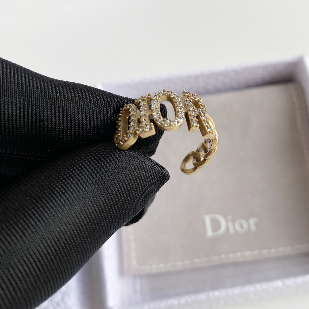 Gold ring with gems and brand name engraved on it. - Image 4