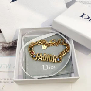 Linked chain Gold bracelet with J@D!0R cut out and Gems inlaid.