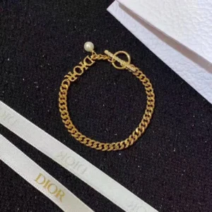 Linked chain gold bracelet with D!0R cut out.