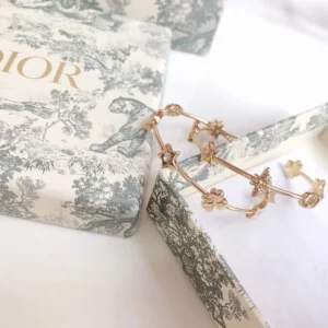 Alternative view of Golden hoop earring with stars,leafs decorated in circle.