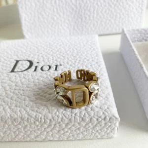 Alternative view of Gold ring with gems and D engraved on it.