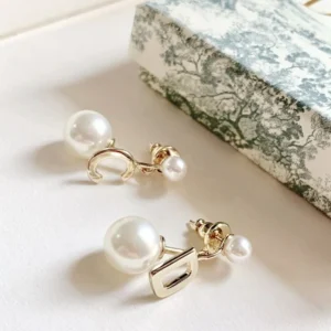 Golden drop earring with D cut out and white pearls.