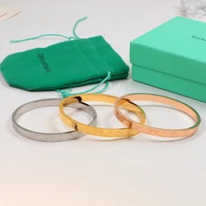 Alternative view of Hinged Smooth bangle with brand name engraved on it.