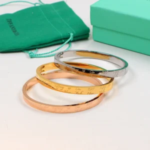 Hinged Smooth bangle with brand name engraved on it.