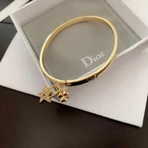 CD imprinted plain gold Bracelet /Bangle with star and clover leaf motif.