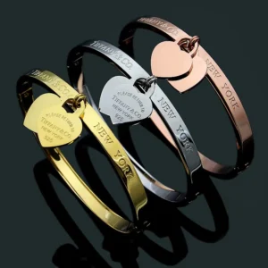 Smooth Bangle with heart shaped charm.