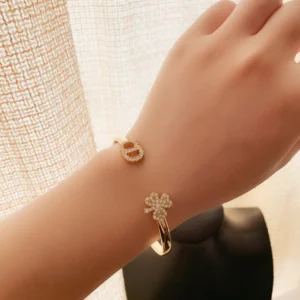 Plain gold Bracelet /Bangle with CD cutout and clover leaf motif.