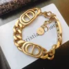 Linked chain gold bracelet with double CD cutout.