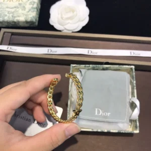 Linked chain gold bracelet with star in centre.