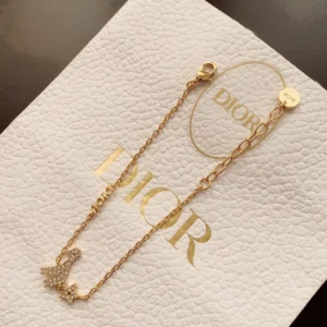 Alternative view of Linked chain gold bracelet with diamond inlaid star and giraffe motif.