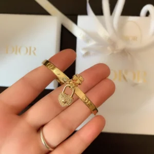 CD imprinted plain gold Bracelet /Bangle with lock and clover leaf motif.