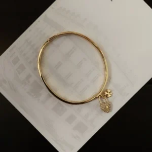 Alternative view of CD imprinted plain gold Bracelet /Bangle with lock and clover leaf motif.
